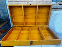 open wooden box showing lid and base compartments