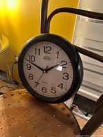 Front view of GEO wall clock showing full face, numerals and casing