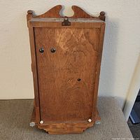 Rear view of wood case showing hanging hardware
