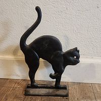 Front angled view of cast iron cat showing stance and base