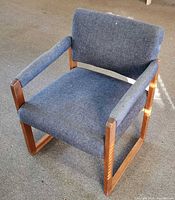 Front angle of armchair showing upholstery and wood frame