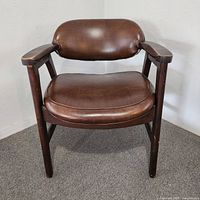 Front view showing brown vinyl seat and wood frame