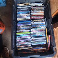 Large plastic tote filled with rows of DVD and Blu-ray movie cases
