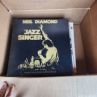 Neil Diamond The Jazz Singer LP at top of vinyl stack in box