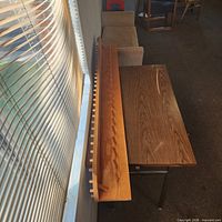 Front view of full-length wooden coat rack on table