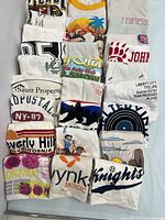 All 23 folded grey T-shirts arranged in grid