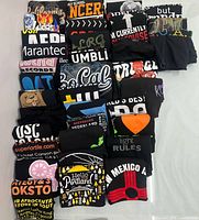 All 37 folded black graphic T-shirts laid out in rows