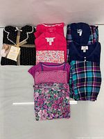All four pajama sets laid out unbagged showing patterns and colours
