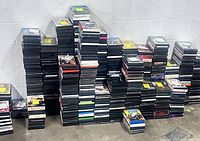 Wide view of multiple columns of stacked DVD cases against wall