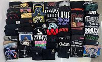 Front view of all folded shirts showing variety of graphics