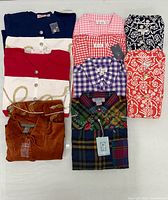 All nine folded shirts showing patterns and tags