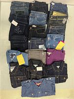 All 18 folded denim garments displayed together