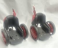 Side view of both red RocketSkates showing wheels and foot platforms