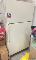Front view of Whirlpool refrigerator showing doors, handle, badge