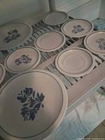 Overview of twelve Pfaltzgraff plates on shelf