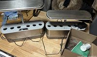 Two AeroGarden units, cords, box with plant food and pod supplies