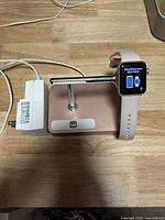 Apple Watch on charging stand with power adapter visible