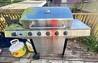 Front view of stainless Char-Broil Performance propane grill on cart