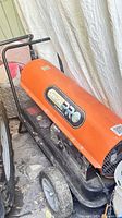 Dyna-Glo PRO orange torpedo heater on wheeled base with handle
