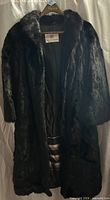 Front view of fur coat on hanger