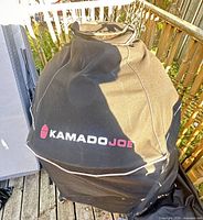 Kamado Joe branded black protective cover over grill