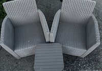 top view of two grey resin wicker-look chairs and square side table