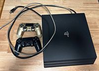 Top view of PS4 console, two controllers, power and braided cables