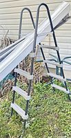 Full view of ladder showing five steps, handrails, and material details