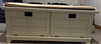 front view of off-white storage bench with cushion