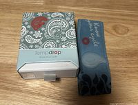 Tempdrop box beside blue armband