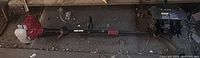 Full view of string trimmer powerhead, shaft and separate cultivator attachment
