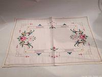 Single table runner laid flat showing full embroidery and cutwork border