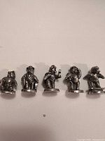 Front view of all five pewter teddy bear figurines in a row