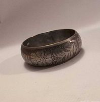 oblique view of bracelet showing engraved floral design