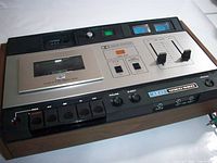 Front view showing faceplate, controls, VU meters, cassette compartment