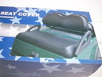 Box front showing image of installed gray seat covers