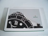 Front cover showing Rolex bezel image and logo