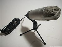 Microphone on tripod stand with cable visible