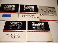 Front view of five Scotch 7-inch tape reel boxes showing model numbers and handwritten labels