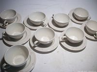 Nine cups and nine saucers displayed