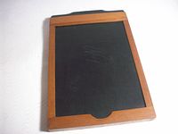 Front view of wooden film plate holder showing wood frame and black dark slide