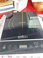 Top view of Salton single-burner induction cooktop showing glass surface and control panel