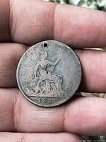 Reverse side showing Britannia, date 1884, drilled hole top