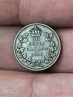 Reverse of 1914 Canada 10-cent silver coin showing denomination, date and wreath design
