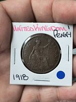 Reverse side showing seated Britannia design and date 1918 in cardboard flip
