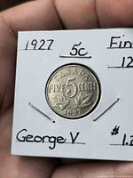 Close-up of 1927 Canada 5 Cents coin in holder showing reverse design and date