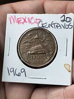 Reverse view of coin showing denomination, landscape, date