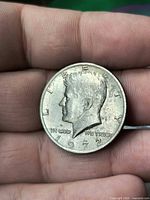 Obverse view of 1972 Kennedy Half Dollar in hand showing portrait, date, legends