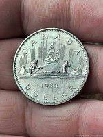 Coin reverse showing Voyageur canoe design and 1982 date