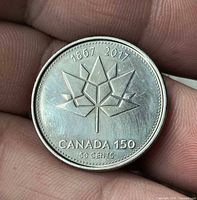 Reverse side close-up showing Canada 150 maple leaf design and legends